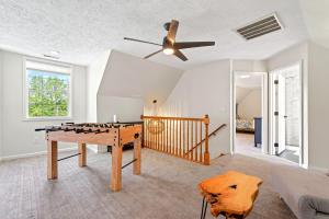 a living room with a ping pong table and a ceiling fan at Calm Water Cove in Nebo
