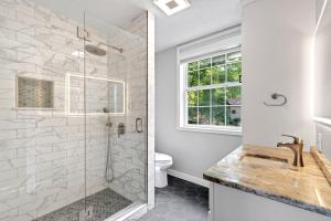 a white bathroom with a shower and a toilet at Calm Water Cove in Nebo +45 photos