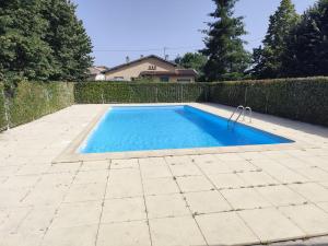 a swimming pool in a backyard with a fence at La bastide de Montech in Montech