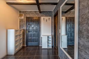 a hallway with two doors and a tiled floor at Vila Deniri in Zlatibor +243 photos