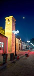 a clock tower with a street light in front of it at Stan na dan Harmonija in Nevesinje