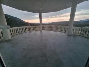 a balcony with a view of the mountains at Kalanar villa in Elbasan +1 photo