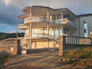 a large house with a balcony and a staircase at Kalanar villa in Elbasan
