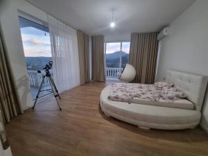 a bedroom with a camera and a bed and a tripod at Kalanar villa in Elbasan