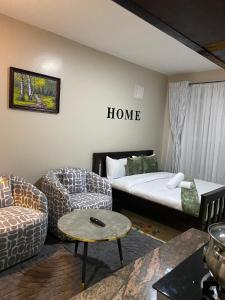 a living room with a bed and a couch at The Cozy Corner Studio in Ruaka