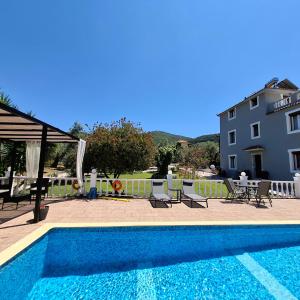 a swimming pool in front of a building at Georgia apartments in Stafylos