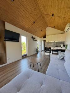 a living room with a couch and a table at Domek nad Drawskim in Stare Drawsko