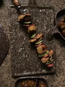 a bunch of food on a table with a spatula at Woodlands Wilderness Chalet in Mādāri Hāt