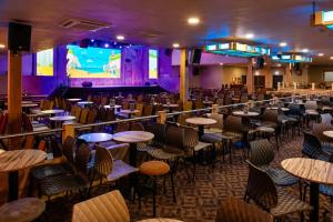 a restaurant with tables and chairs and a stage at 7 Jay Valley in Bridlington