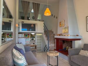 a living room with a couch and a fireplace at Casa Helios Fourka Beach Retreat in Skala Fourkas