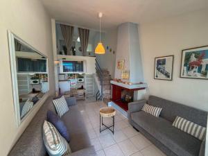 a living room with a couch and a fireplace at Casa Helios Fourka Beach Retreat in Skala Fourkas