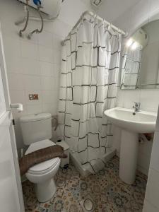 a bathroom with a toilet and a sink at Casa Helios Fourka Beach Retreat in Skala Fourkas +13 photos