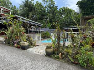 a garden with plants and a swimming pool at Domaine Damouw in Petit-Bourg