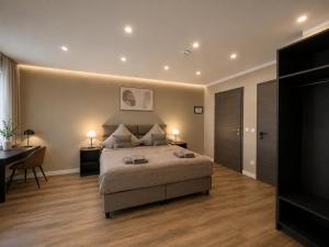 a bedroom with a bed and a desk and a table at StadtBlick Hotel in Bad Salzuflen