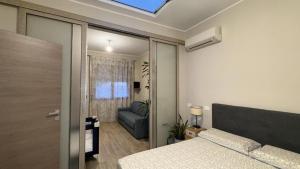 a bedroom with a bed and a couch and a window at Domu de Ziu Peppino in Sìnnai