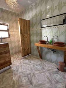 a bathroom with a tiled floor and a sink at DAR SANAE SURF in Aourir +80 photos