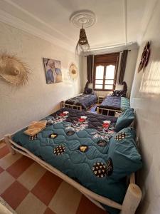 a bedroom with two beds in a room at DAR SANAE SURF in Aourir