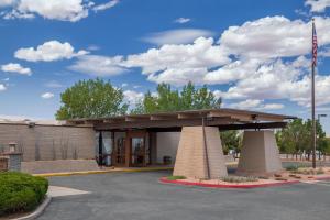 a building with an american flag in a parking lot at Kayenta Monument Valley Inn in Kayenta