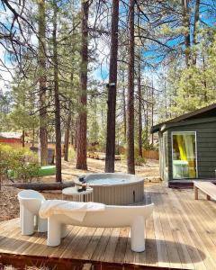 a wooden deck with a bench and a coffee table at Colorado Lodge in Big Bear Lake