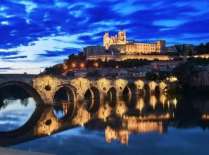 a bridge over a river with a castle in the background at L'Etoile Biterroise - Location appartement de vacances - Béziers in Béziers