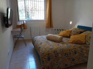 a bedroom with a bed with two pillows on it at L'Etoile Biterroise - Location appartement de vacances - Béziers in Béziers +29 photos