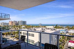 a balcony with chairs and a view of the ocean at CW Hotel in Clearwater Beach