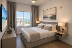 a bedroom with a large bed and a large window at CW Hotel in Clearwater Beach +98 photos
