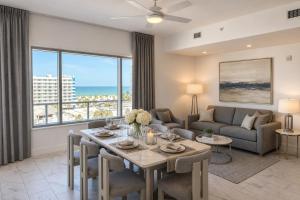 a living room with a table and a couch at CW Hotel in Clearwater Beach