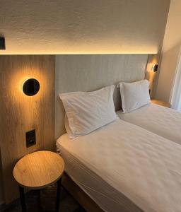 a hotel room with two beds and a table at Hotel Angela in Asprovalta