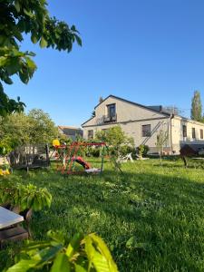 a yard with a playground in the grass at Rancho by HV in Sevan