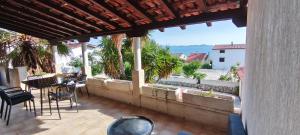 a patio with a table and chairs and a view of the ocean at Apartment Sofia in Kožino