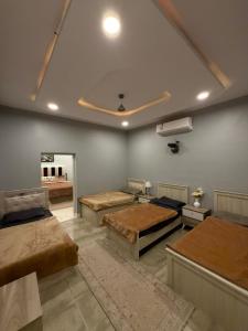 a room with four beds in a room at بيت وقف الخير اسبوعي وشهري Charity endowment house, weekly and monthly in Medina +83 photos