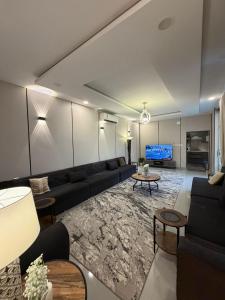 a living room with a couch and a tv at بيت وقف الخير اسبوعي وشهري Charity endowment house, weekly and monthly in Medina