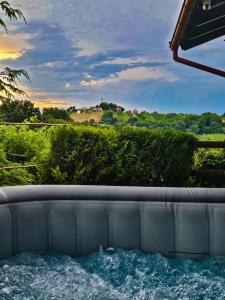 a hot tub with a view of a house at Kuća za odmor Štefi in Donji Koncovčak