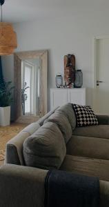 a large couch in a living room with a mirror at The Cozy Corner in Turku