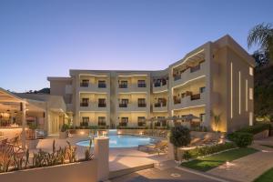 an exterior view of a hotel with a swimming pool at Amalia Apartments-Suites in Bali