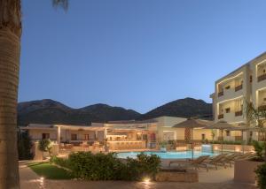 a view of the hotel and the pool at night at Amalia Apartments-Suites in Bali