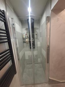 a shower with a glass door in a bathroom at Apartman IDEA in Rabac +29 photos