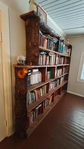 a book shelf filled with books in a room at Inka's Guesthouse in Alavus