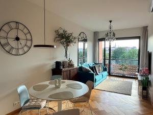 a living room with a table and a blue couch at Old Town Fabulous view apartment in Tallinn
