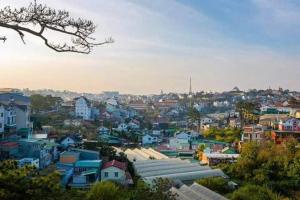 a view of a city with houses and buildings at Pine Aura Dalat Inn in Da Lat