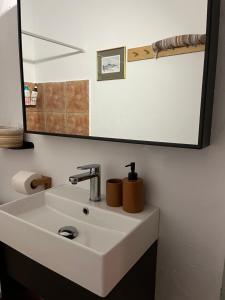 a bathroom sink with a large mirror above it at Salt & Sun Terrace Seafront in Agioi Apostoli +14 photos