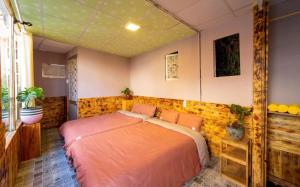 a bedroom with a large bed in a room at Pine Aura Dalat Inn in Da Lat