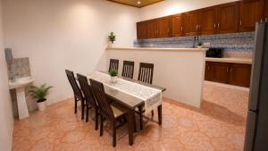 a dining room with a table and chairs in a kitchen at Amazonite Maldives in Thulusdhoo