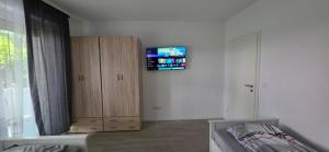 a bedroom with a bed and a tv on the wall at RM Apartaments in Bochum