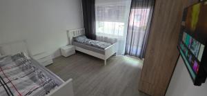 a small room with a bed and a window at RM Apartaments in Bochum