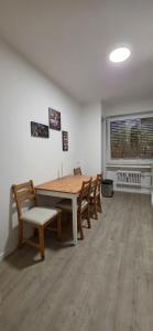 a dining room with a wooden table and chairs at RM Apartaments in Bochum