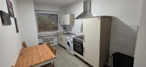 a small kitchen with a stove and a refrigerator at RM Apartaments in Bochum +2 photos