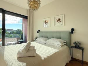 a bedroom with a large white bed with a window at Old Town Fabulous view apartment in Tallinn