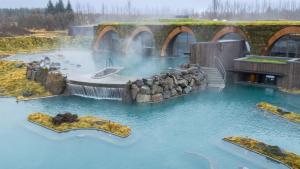 a water park with a waterfall and a bridge at Brúarárbyggð A2 in Blaskogabyggo